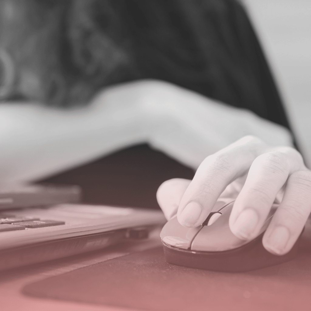 ISO 22301 Thumbnail 2 Close up of a woman holding a mouse, using a laptop