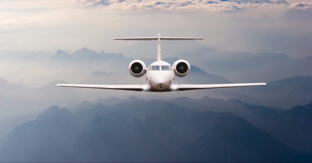 Airplane fly over clouds and Alps mountain on sunset. Front AS9100