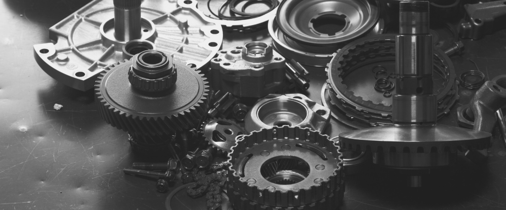 IATF 6949 Header B&W A group of gears and parts