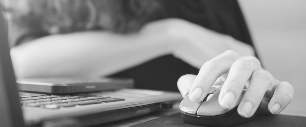 A close-up of a hand using a mouse