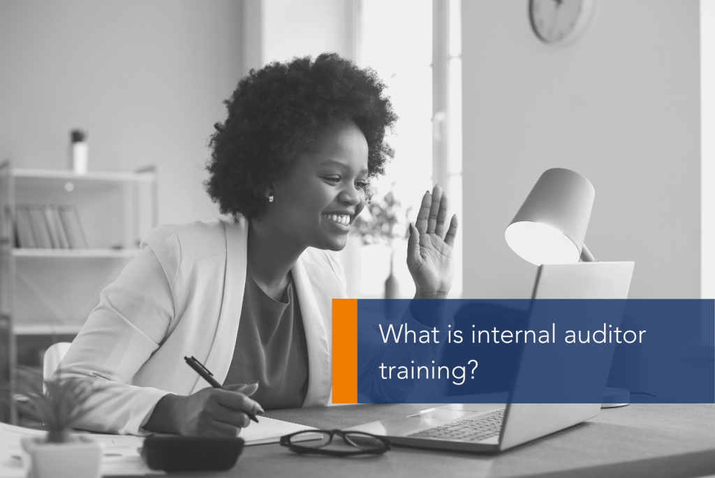 What is internal auditor training MAIN A person sitting at a desk with a computer and a lamp