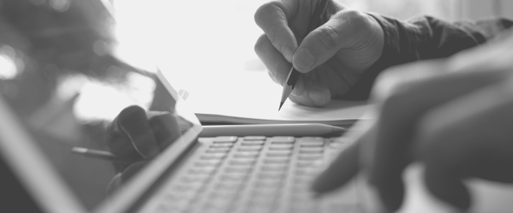 Training New Header Close-up of a hand writing on a piece of paper
