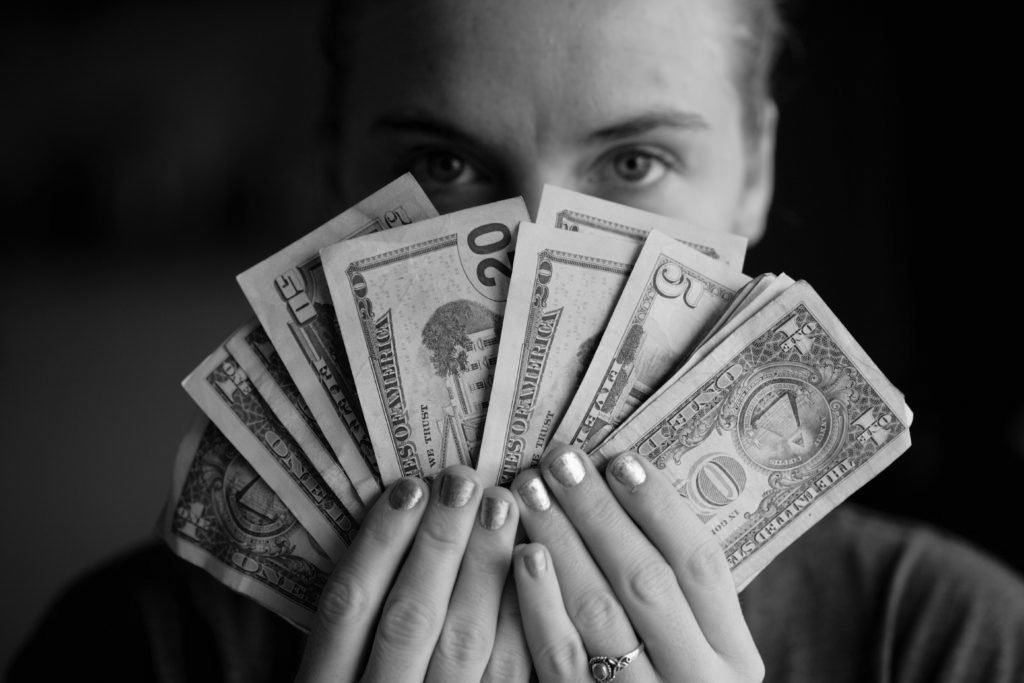 Woman holding up money