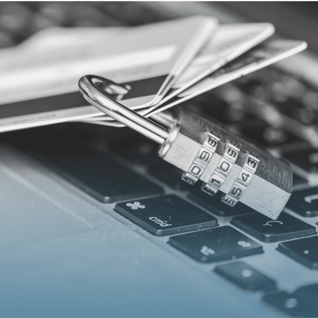 Close up of a padlock and credit cards on a laptop