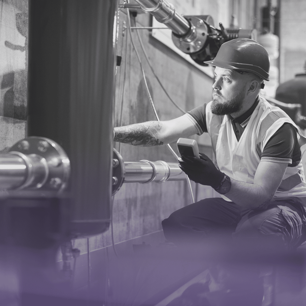 A main wearing PPE inspecting pipework