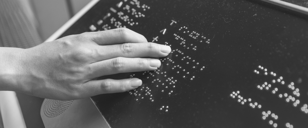 Accessibility New Header A hand touching a garmentille board